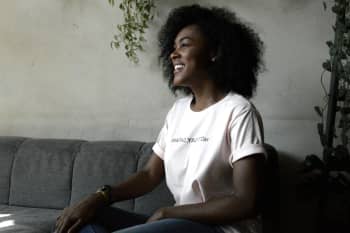 woman smiling sitting on sofa